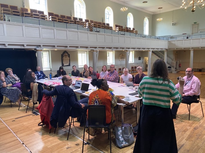 Photo from the Culture Board meeting, quarter two of 2024, with board members discussing the culture strategy around a table at St George's, Bristol.